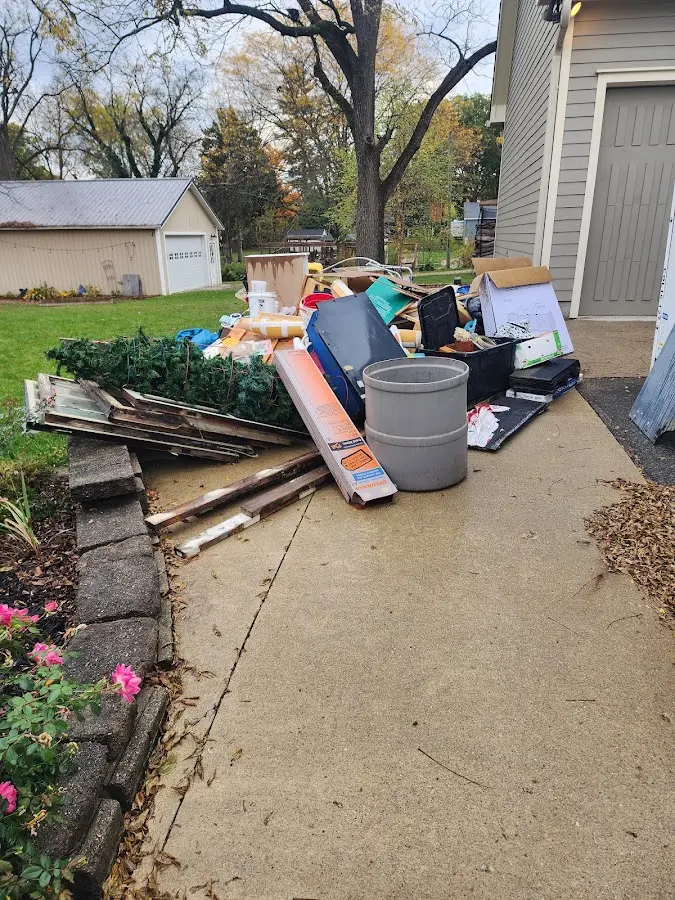 Dumpster being loaded with debris for Roofing Dumpster Rental in Stokesdale